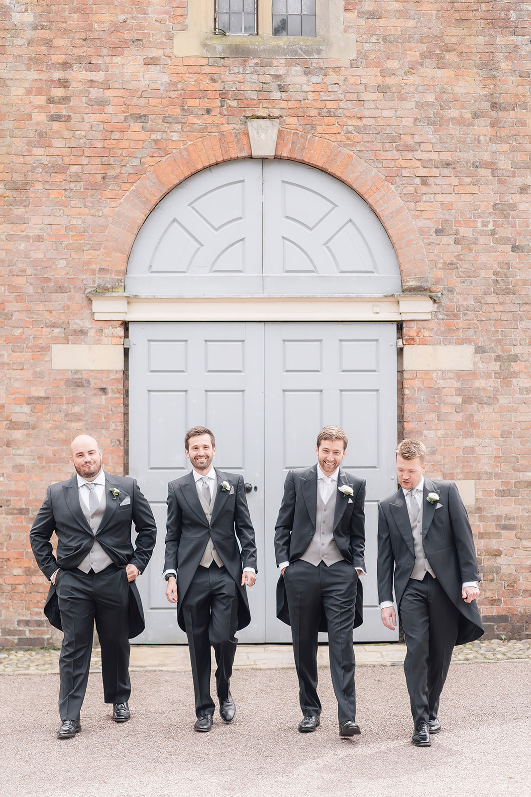 men walking in suits Dorfold hall Cheshire