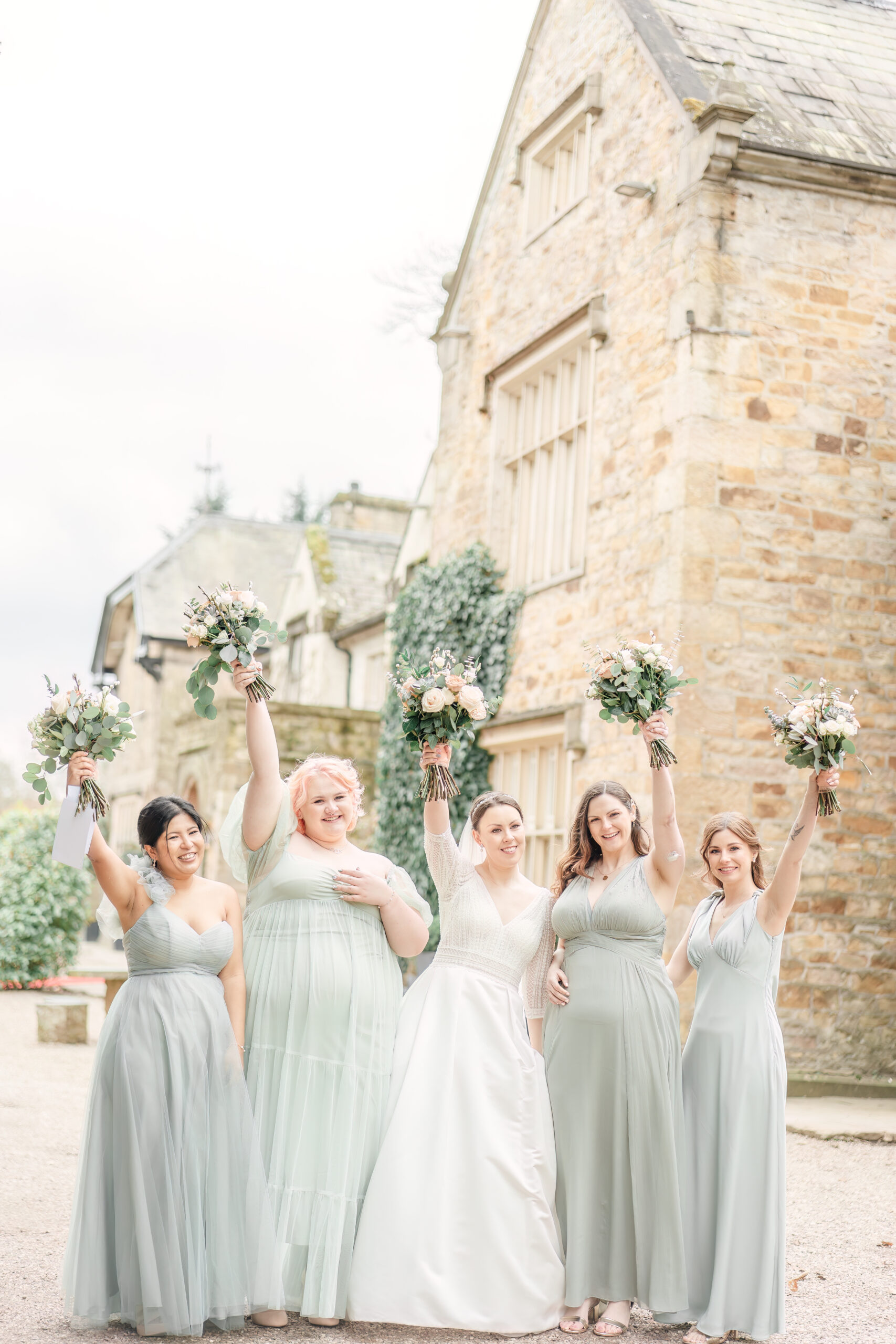 bridesmaids putting flowers in the air