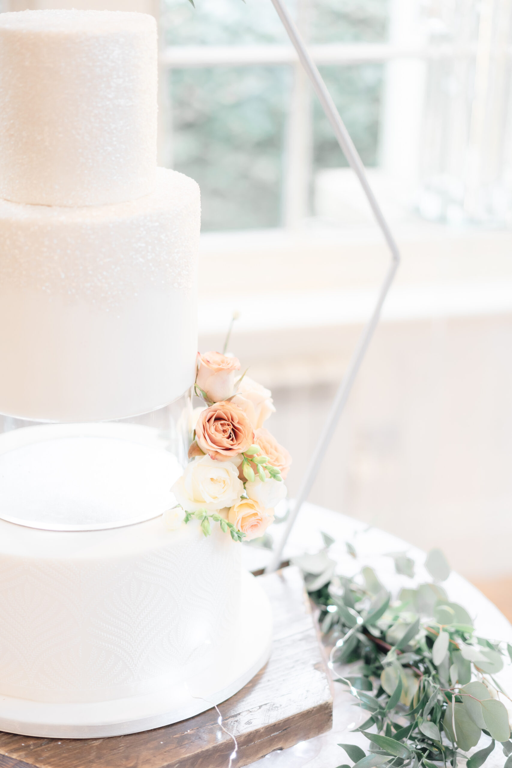 part of a wedding cake with flower fir Mitton Hall Wedding